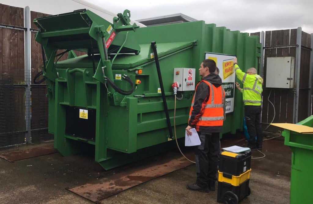 Portable hook-lift compactor being installed at Kirkby Market